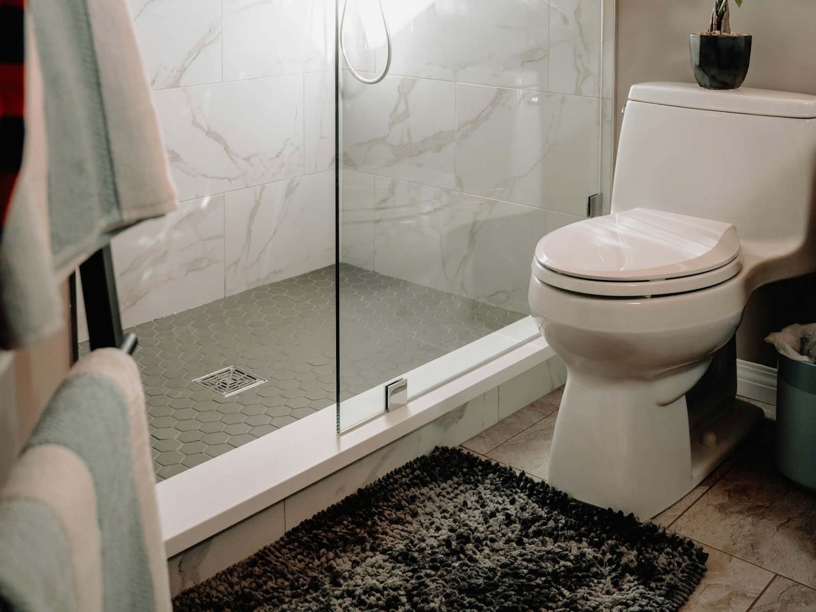 Rundes Sieb aus Metall liegt auf einem Duschabfluss